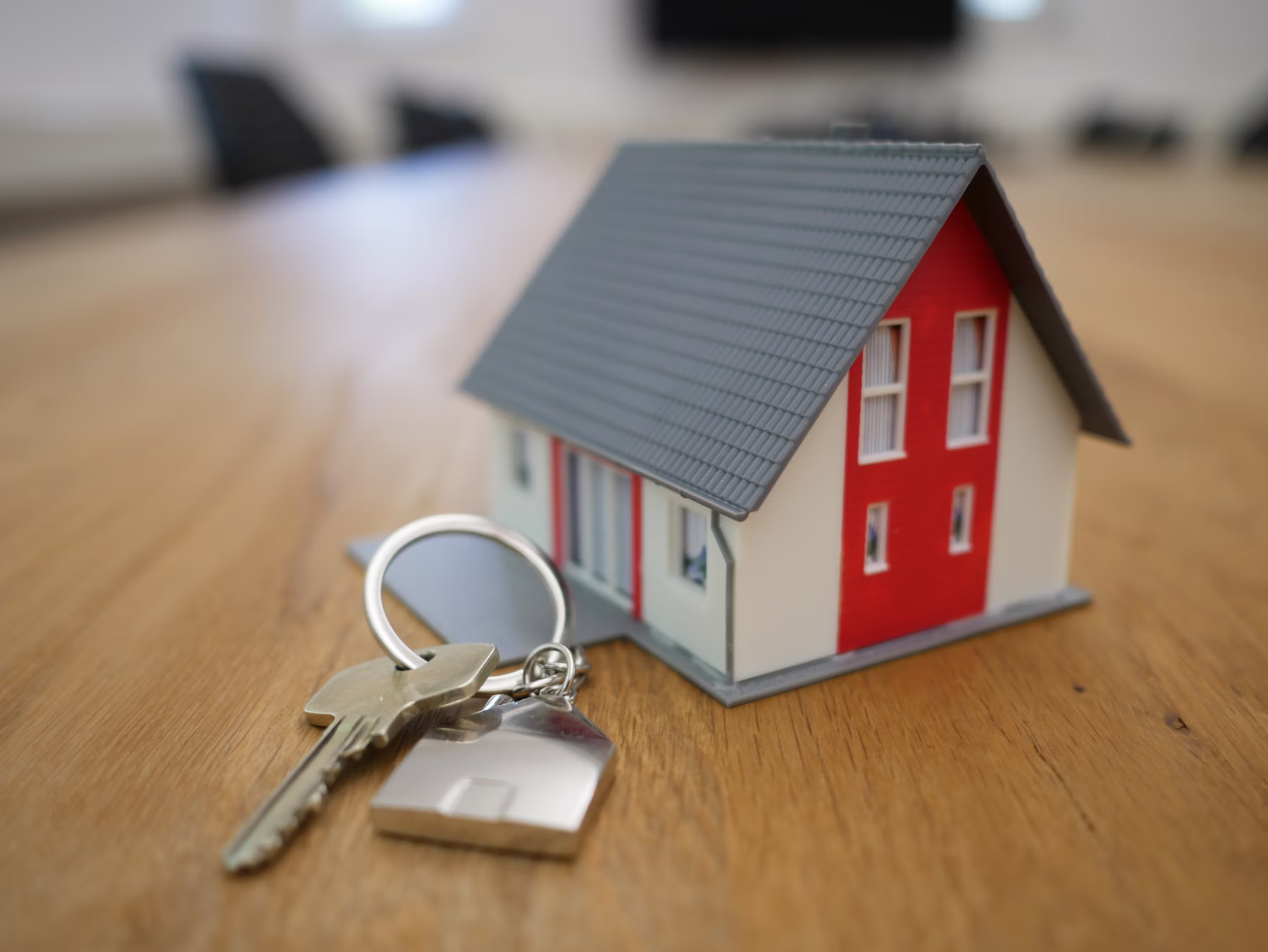 Hands passing house keys symbolizing relocation services